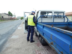 Policjant kontroluje kierującego truckiem.