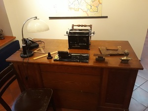 Jedna z ekspozycji wystawy: biurko, maszyna do pisania i podręczne przybory