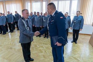 Komendant wręcza nagrodę policjantowi