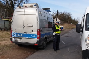 Policjant RD sprawdza za pomocą urządzenia jakość spalin