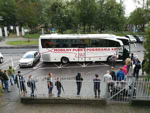 widok na osoby stojące w kolejce do krwiobusa