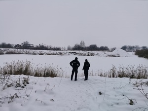 Policjanci na zimowych łąkach.