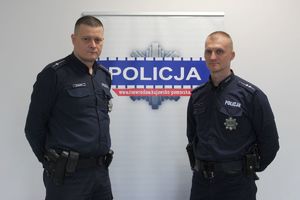 Policjanci na tle baneru.