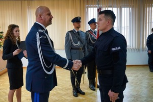 Komendant podaje dłoń policjantowi