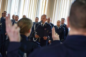 ujęcie zza ramienia policjanta na Komendanta Wojewódzkiego Policji w Bydgoszczy, który czyta Rotę ślubowania