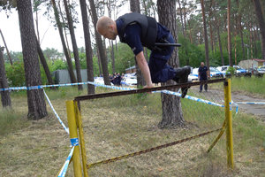 policjant przeskakuje przez płotek