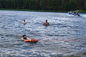 mężczyzna trzyma się koła ratowniczego będąc w wodzie