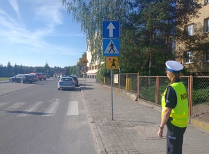 Policjantka stoi w pobliżu szkoły