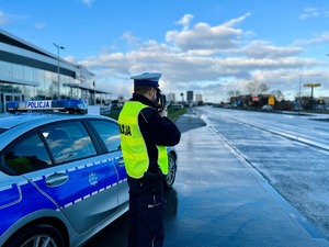 Policjant w trakcie pomiaru prędkości.