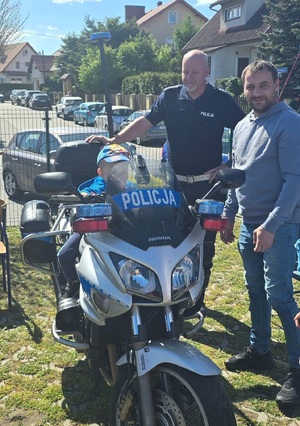 Policjanci wzięli udział w pikniku profilaktycznym w Osiu, pokazują uczestnikom policyjny sprzęt i biorą udział w zabawach z najmłodszymi