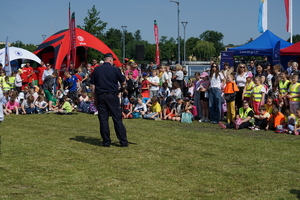 Piknik w Żninie z okazji inauguracji akcji Kręci mnie bezpieczeństwo w lecie. Dzieci i młodzież oglądają stanowiska różnych służb