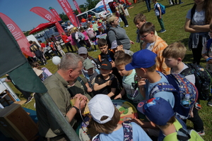 Piknik w Żninie z okazji inauguracji akcji Kręci mnie bezpieczeństwo w lecie. Dzieci i młodzież oglądają stanowiska różnych służb
