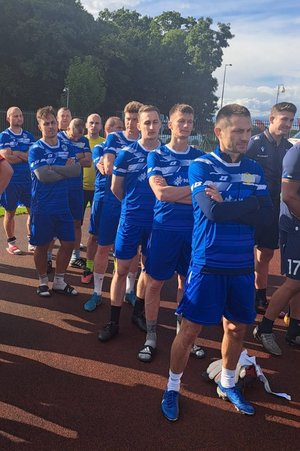 zawodnicy z drużyny stoją jeden za drugim