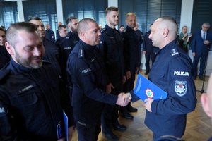 policjanci dostają statuetki i gratulacje od Komendanta i przewodniczącego związków