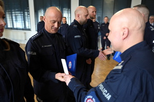 policjanci dostają statuetki i gratulacje od Komendanta i przewodniczącego związków