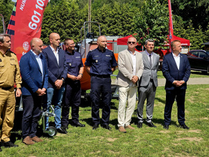 Policjanci w grupie osób na placu.