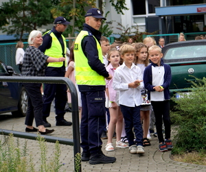 Policjanci oraz policyjna maskotka "Polfinek" podczas akcji "Bezpieczna droga do szkoły"
