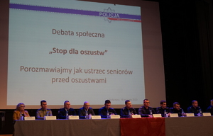 Widok na ekran, na którym wyświetlane są kwestie dotyczące debaty. na dole ekrany prowadzący debatę i organizatorzy
