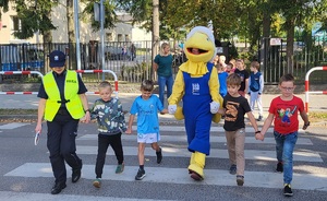 Policjantka ćwiczy przechodzenie przez przejście dla pieszych  z dziećmi w Szkole Podstawowej nr 1 w Więcborku