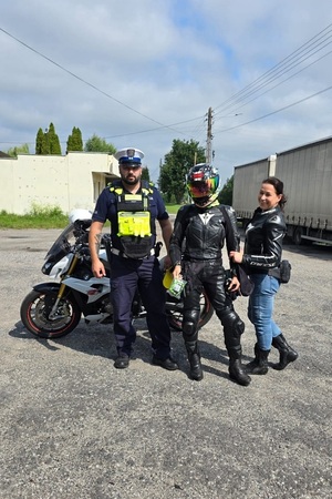 Policjant z motocyklistami pozują do zdjęcia
